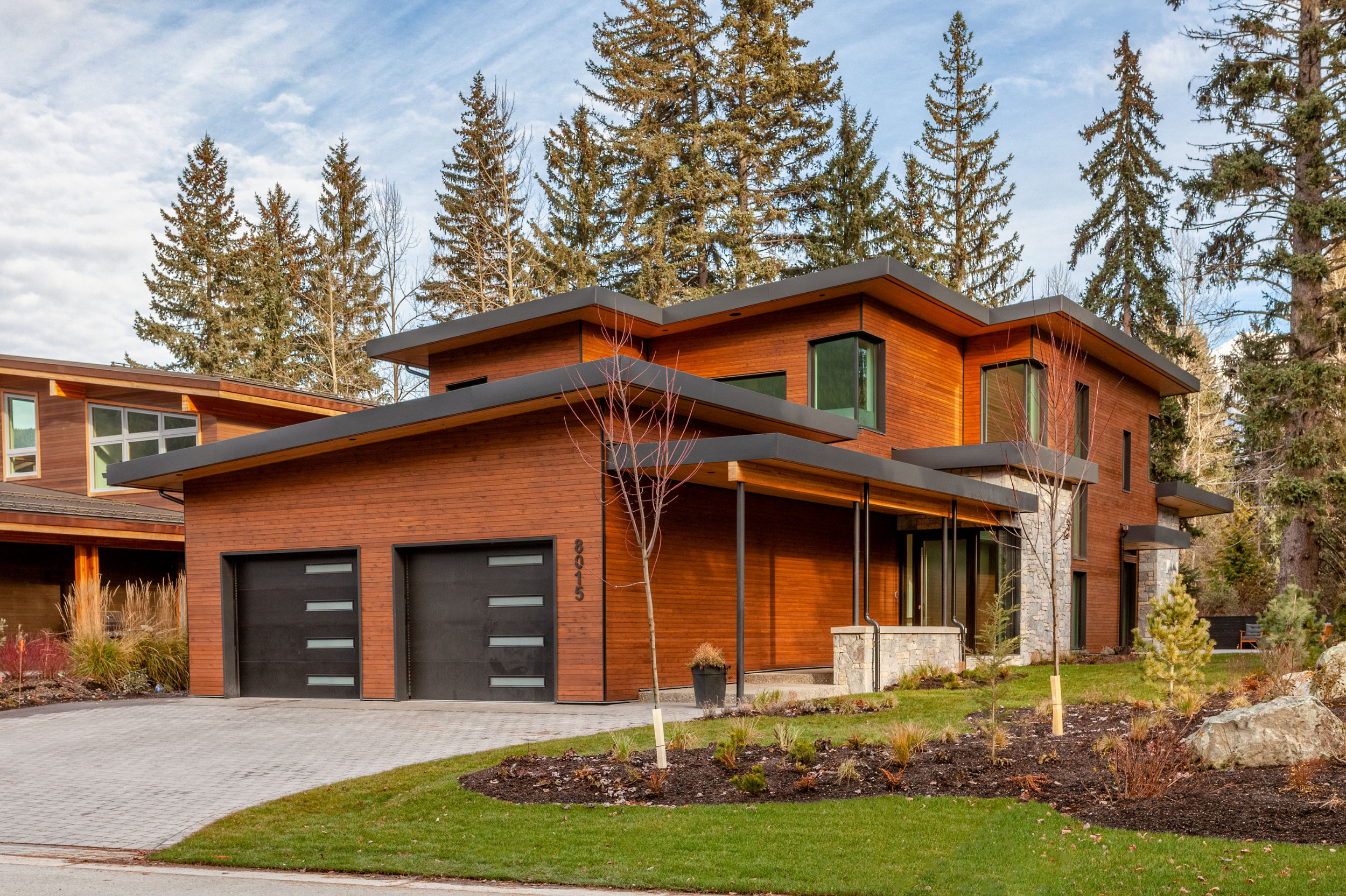 Modern Passive House Exterior - Cyprus Living Energy-efficient custom home exterior with wood and metal siding in Whistler