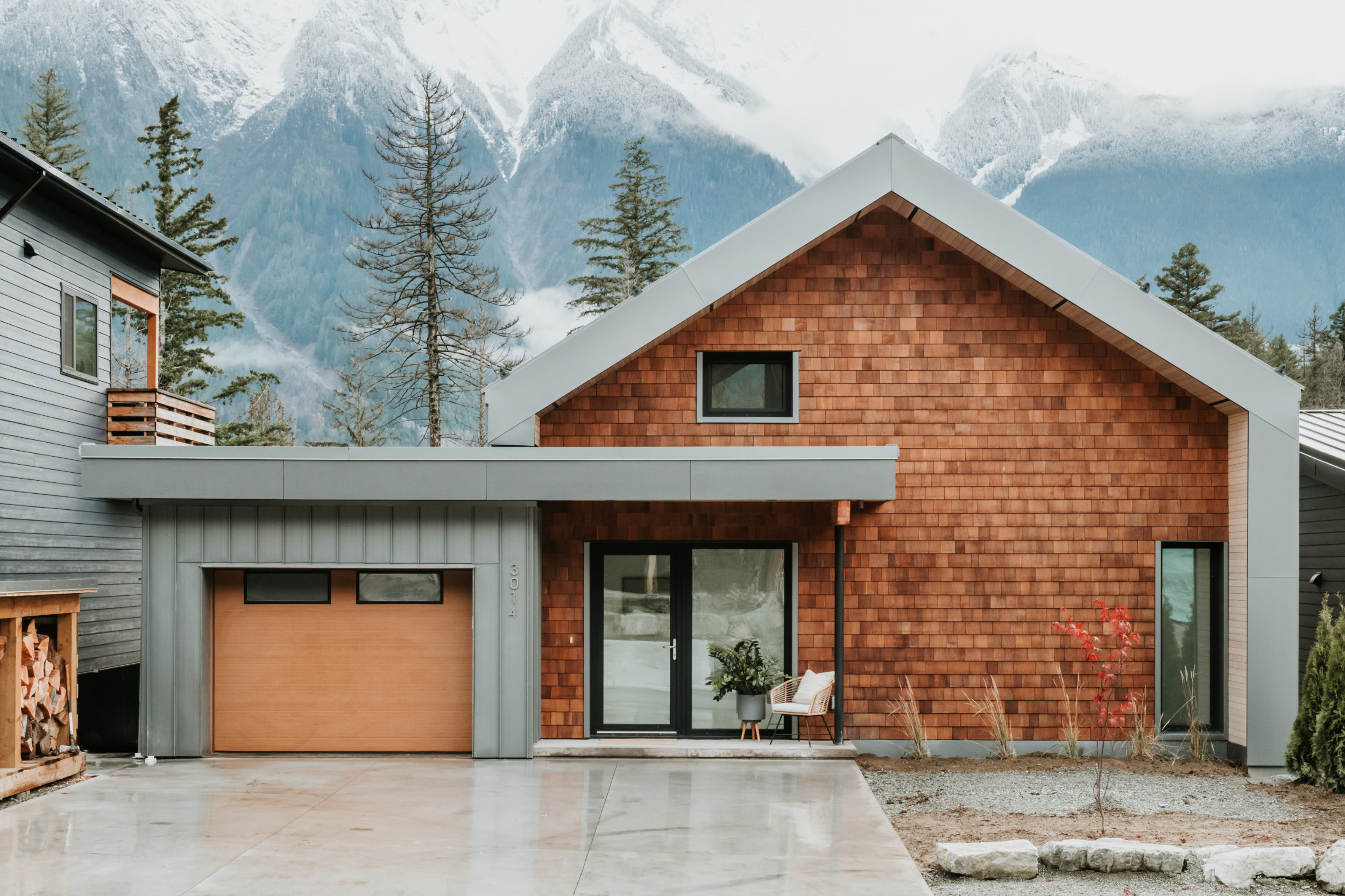 Contemporary Exterior Design - Tenquille Modern Modern home exterior with wood shingle cladding and large windows in Pemberton