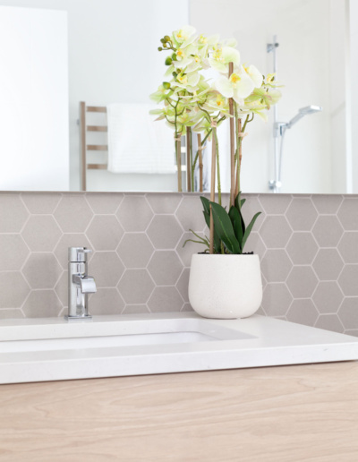 Spa-like bathroom with floating vanity and decorative greenery in luxury Whistler home