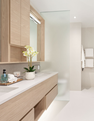 Modern bathroom vanity with marble countertop and elegant lighting in Whistler custom home