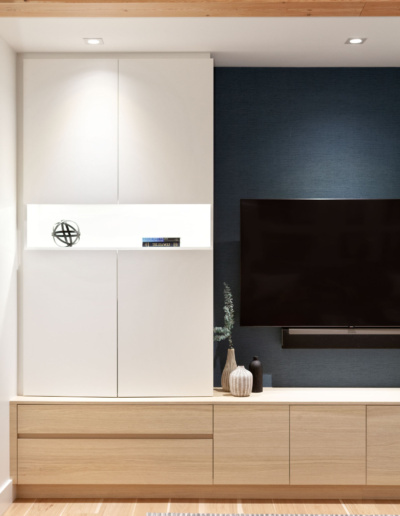 Modern media center with wall-mounted TV and white oak cabinetry in luxury Whistler home