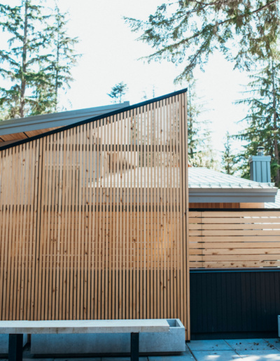 Vertical wood slat privacy screen on modern Whistler home exterior