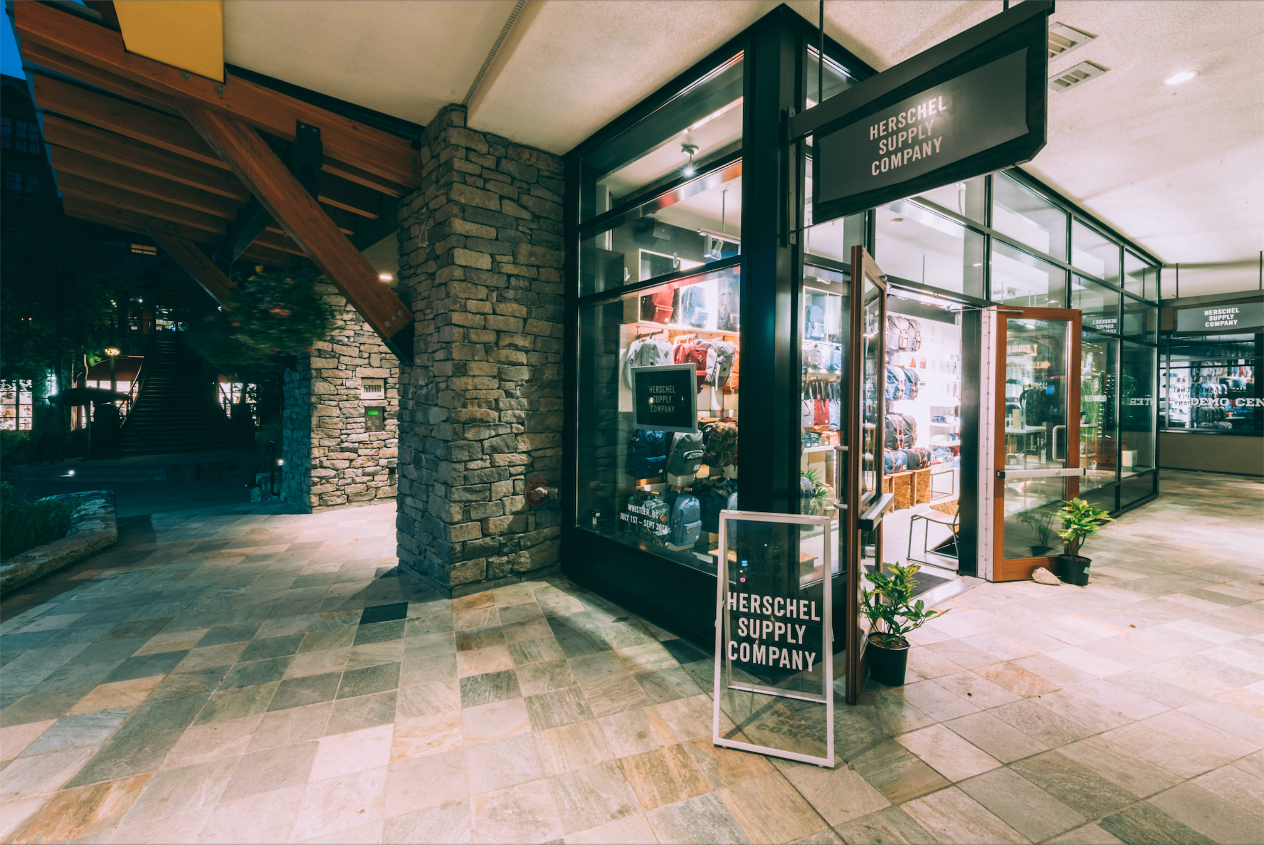 Store Entrance Design - Herschel Supply Co. Whistler Herschel Supply Company entrance with stone accent wall and signage in Whistler