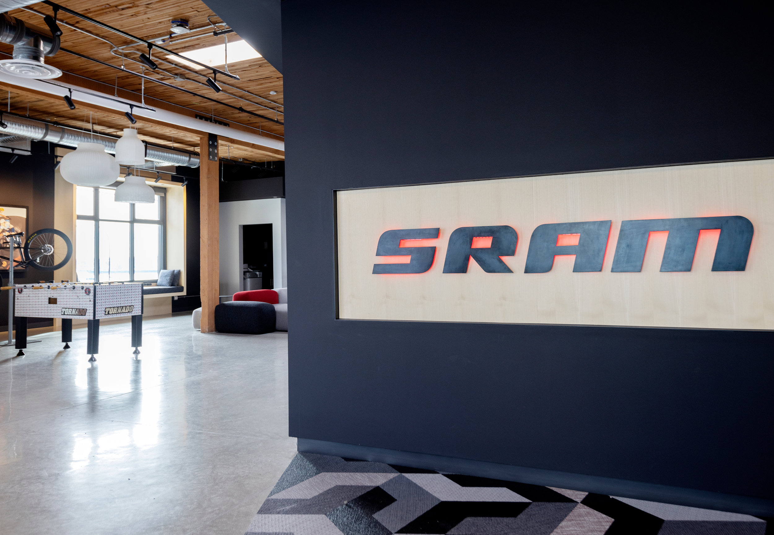SRAM Branded Reception - SRAM Canada Office Space Modern office reception area with SRAM branding and navy accent wall