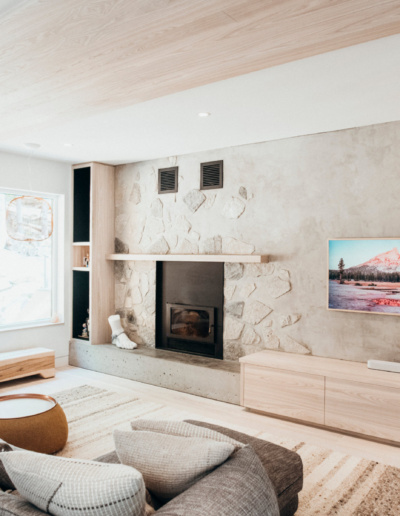 Entertainment wall with fireplace, built-in storage, and custom shelving in Whistler home renovation