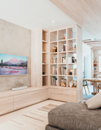 Living area with floor-to-ceiling built-in shelving and open concept view in Whistler renovation